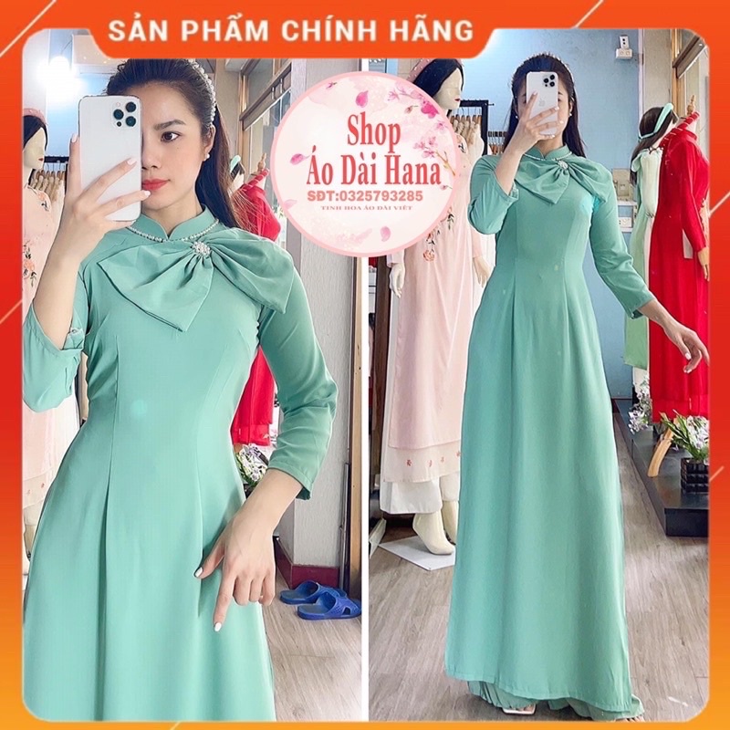 Áo dài cách tân nữ cổ truyền thống đính nơ thủ công, tay lỡ thiết kế trơn một màu điệu.