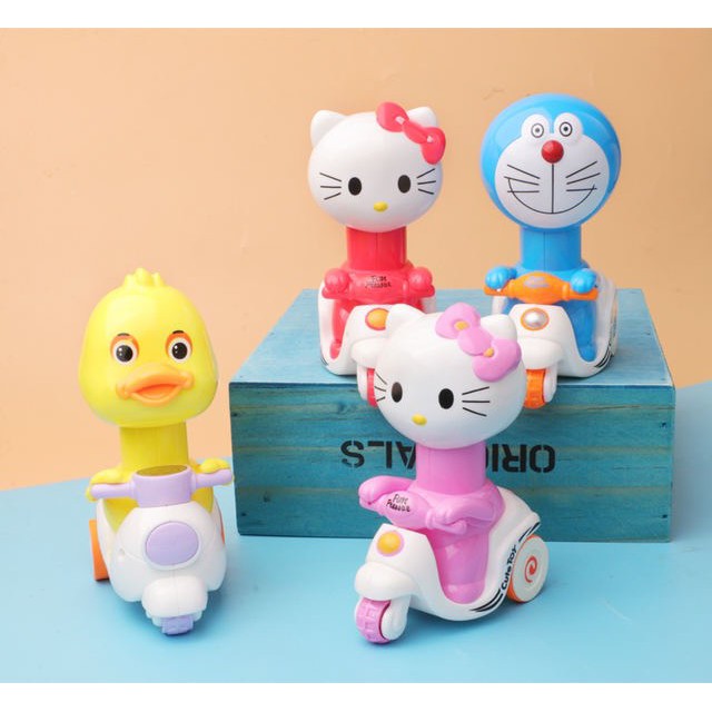 Đồ chơi mèo kitty / Doraemon chạy xe máy cho bé (không dùng pin)