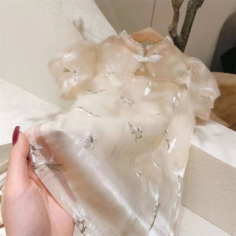 Đầm sườn xám tay phồng IQ Angel đính ngọc trai giả phong cách Trung Hoa cho bé gái