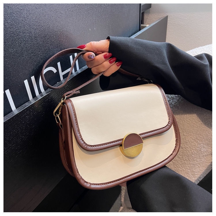 Túi xách nữ đeo chéo khóa tròn kiểu dáng yên ngựa thanh lịch có hai màu trắng và đen