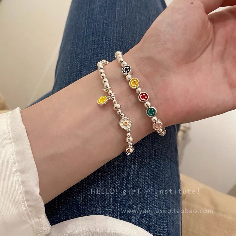 Vòng tay dây cước charm mặt cười-hoa cúc