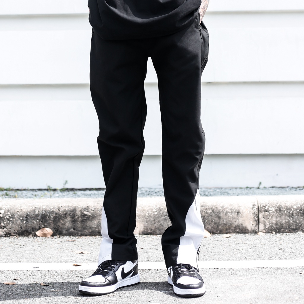 Quần Thun Có Zipper Khóa Sọc Trắng Chất Liệu Vải Dù Ống Rộng Form Unisex Màu Đen