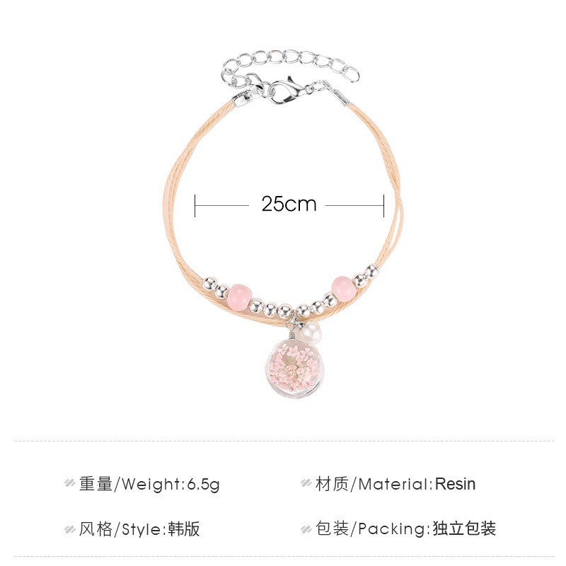 The aqua sphere shaped accessory bracelet contains lovely Korean style dried flowers