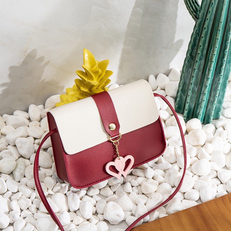 Túi đeo chéo da mềm đính núm tua nữ tính