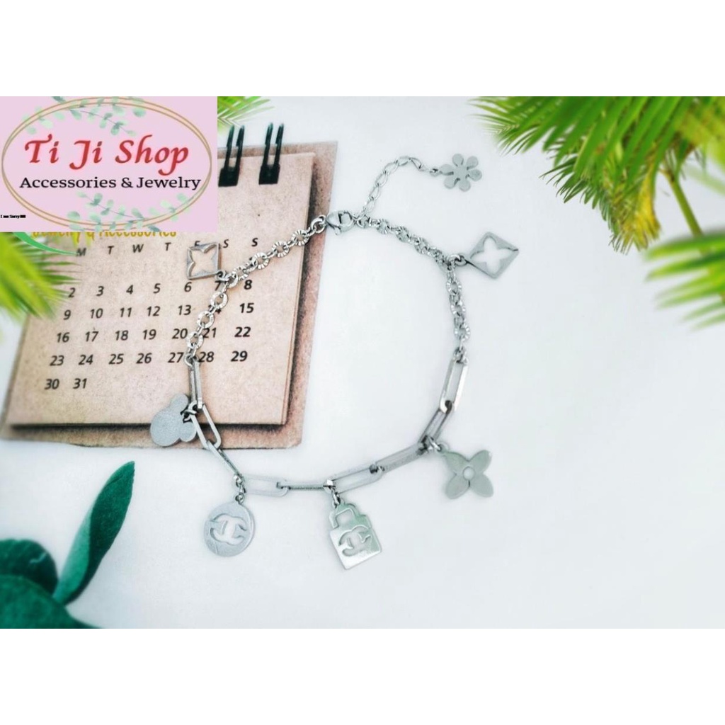 LẮC TAY NỮ INOX GẮN PHỤ KIỆN KHÔNG ĐEN