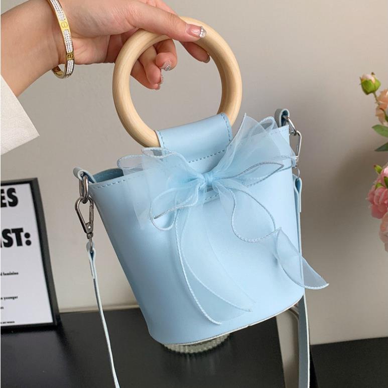 Túi xách nữ túi đeo chéo đẹp kẹp nách đeo vai da pu cao cấp giá rẻ dáng lạ tay cầm gỗ phối nơ xinh xắn TX0023 Hana Bags