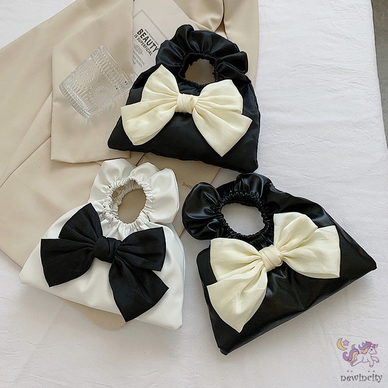 Túi xách cầm tay thiết kế xếp nếp gắn nơ thời trang Hàn Quốc cho trẻ em - người lớn