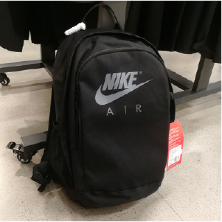The plain color backpack features a unique Nike logo motif