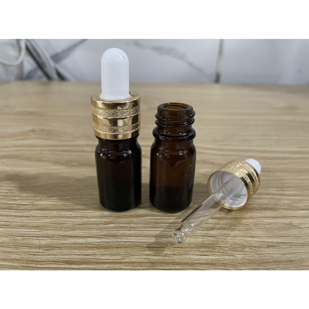 Chai thủy tinh 5ml nâu nắp bóp khoen vàng kiểu đẹp