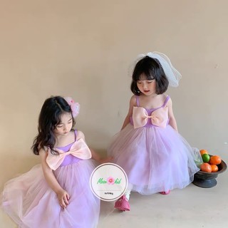 Váy tím nơ ngực bé gái