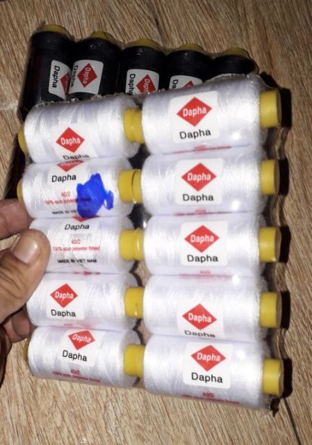 Một cuộn chỉ khâu may vá màu đen hoặc trắng do Việt Nam sản xuất