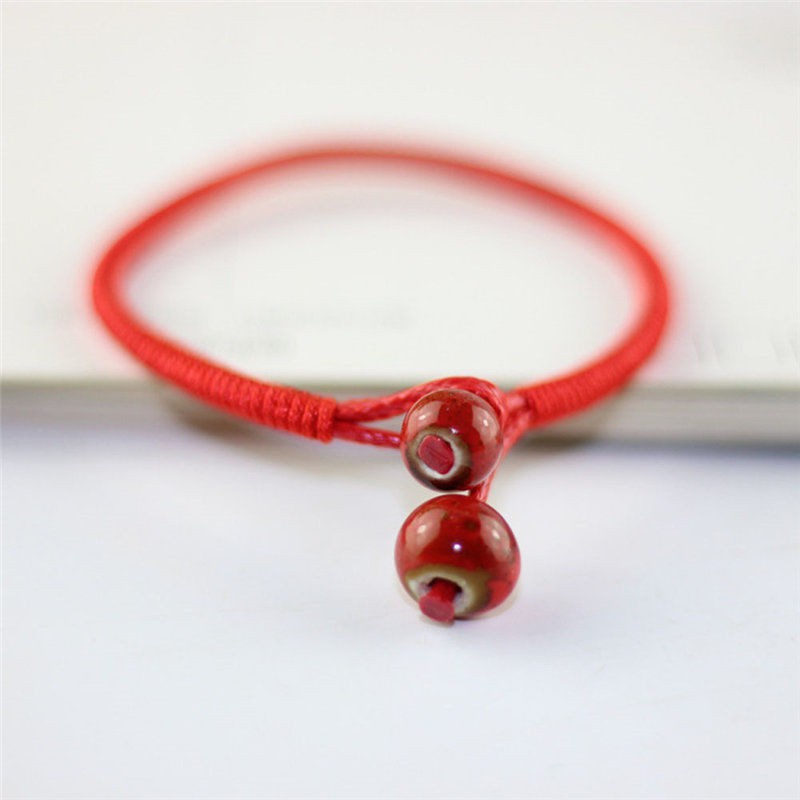 Vòng chỉ đỏ đeo tay dây bện đồng tiền vàng mang lại may mắn | BigBuy360 - bigbuy360.vn