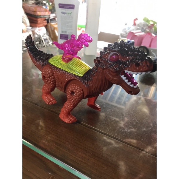 Khủng Long pin cõng con nhạc đèn ( tặng kèm pin)