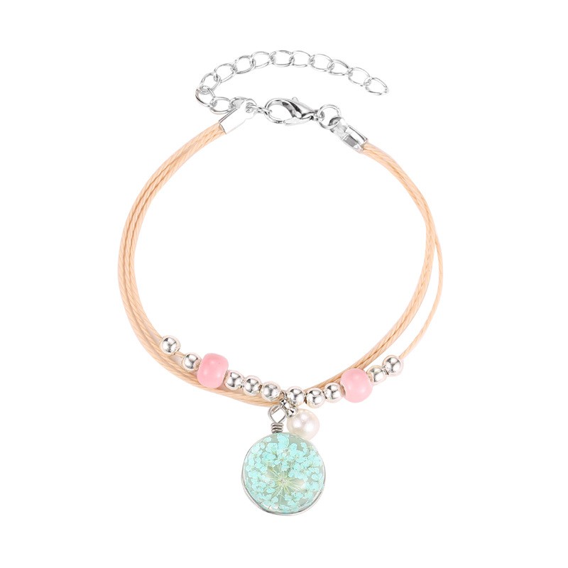 The aqua sphere shaped accessory bracelet contains lovely Korean style dried flowers