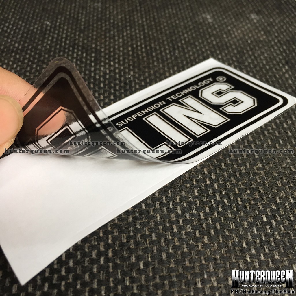 Logo. Oh-Lins[9x3.7cm] trong suốt. Nền đen, chữ xuyên thấu. Hình dán decal siêu dính, chống nước, tem đua trang trí