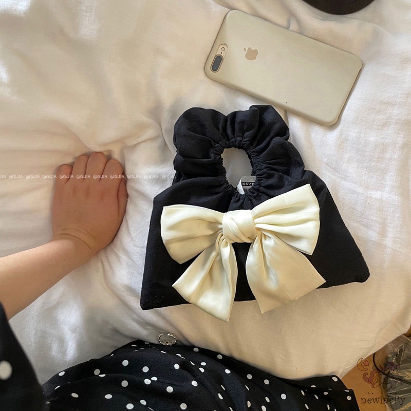 Túi xách cầm tay thiết kế xếp nếp gắn nơ thời trang Hàn Quốc cho trẻ em - người lớn