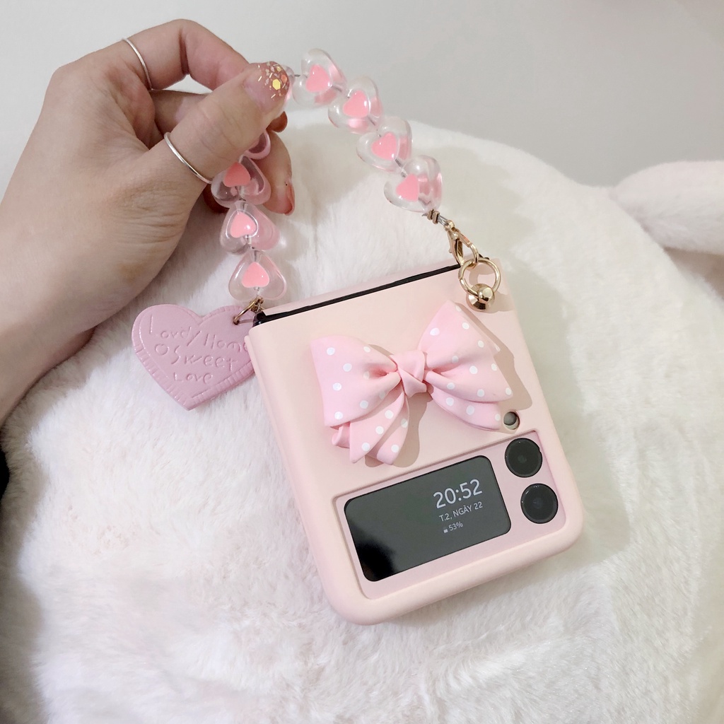 Ốp Samsung Z Flip3 / ZFlip3 / Z Flip4/ ZFlip4 đính nơ có dây xách xinh xắn (2 màu)