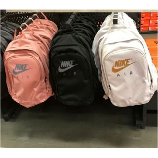 The plain color backpack features a unique Nike logo motif