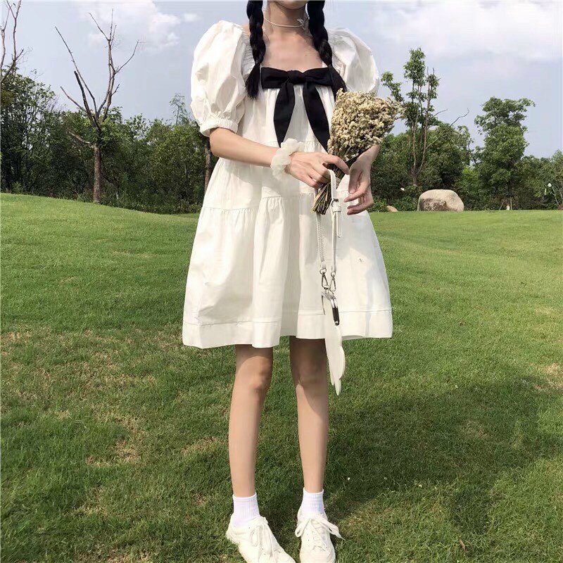 Váy đầm nữ dáng babydoll trắng tay búp có nơ đen trước ngực dễ thương