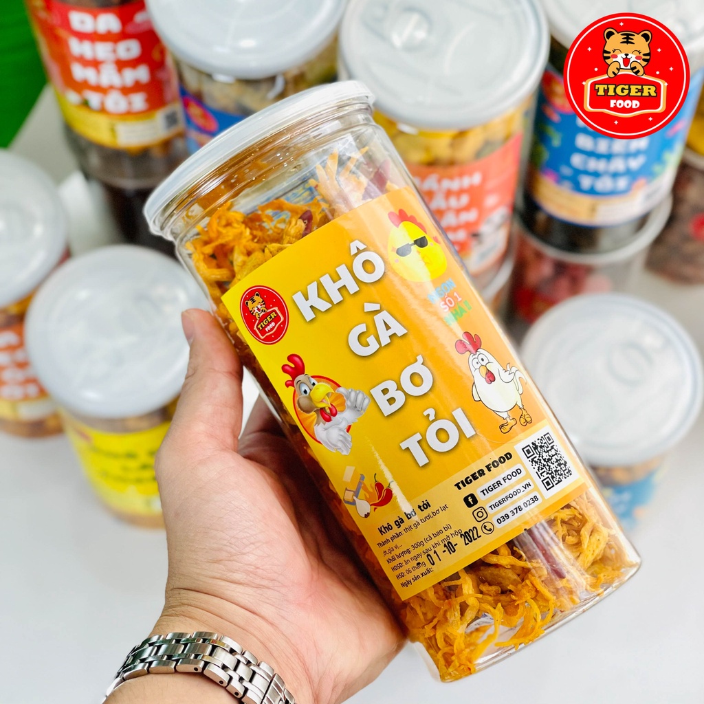Khô Gà Bơ Tỏi Xé Cay TIGER FOOD Khô Gà Bơ Tỏi Đậm Vị Siêu Ngon Lon 300g - Đồ Ăn Vặt Sài Gòn