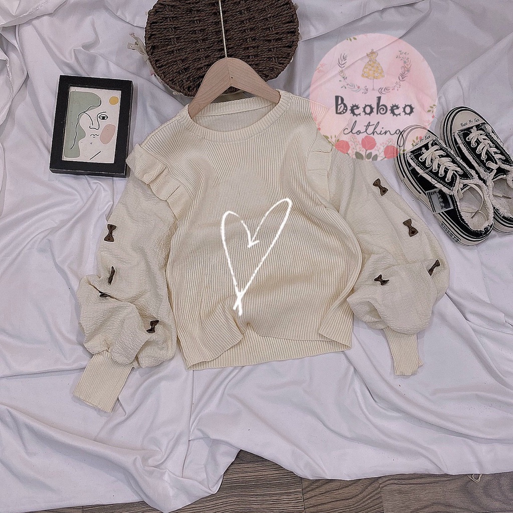 Áo len phối bèo tay phồng nude đính nơ Quảng Châu