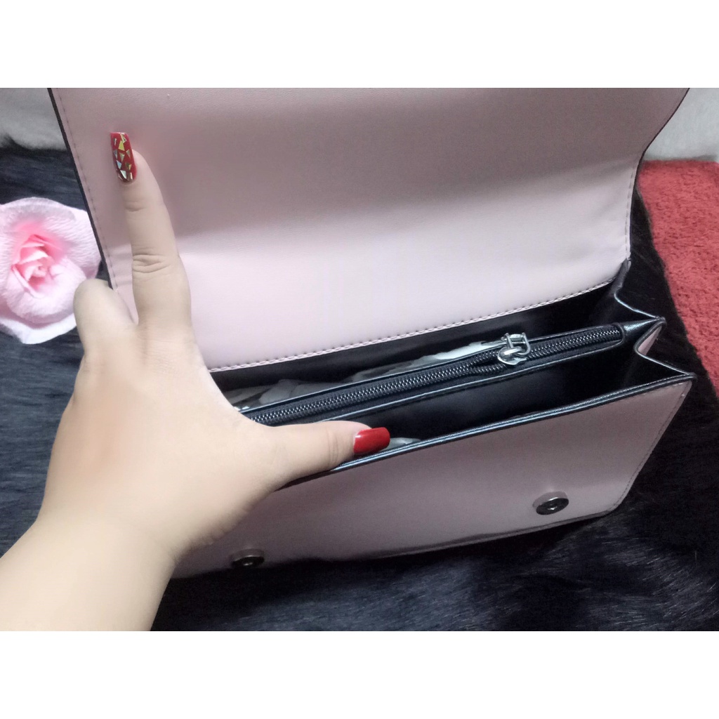 Túi đeo chéo chất da bóng màu hồng có dây đeo phối xích màu bạc, trang trí vân nổi chữ Gucci