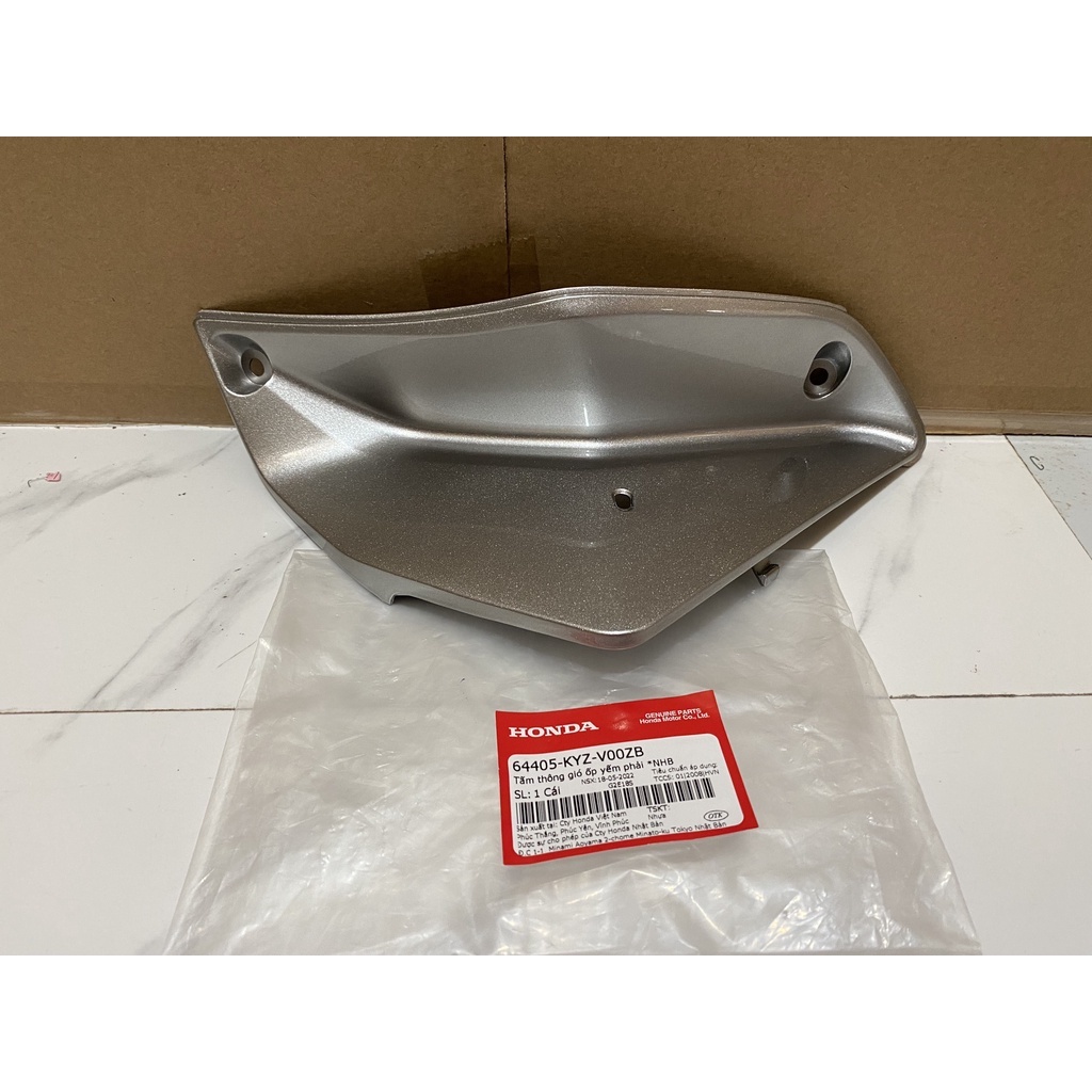 Tấm thông gió ốp yếm phải HONDA FUTURE125 năm 2012 màu Bạc. (64405KYZV00ZB)