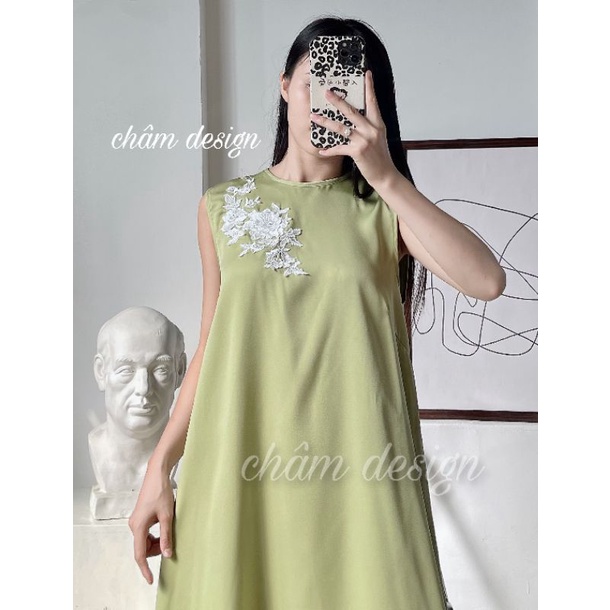 Váy suông lụa xanh cốm cao cấp, thân váy có gắn nơ trắng thêu. Hàng thiết kế tại shop