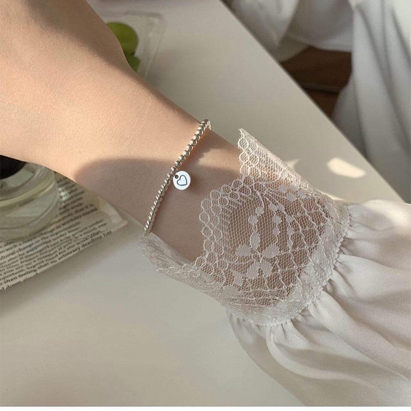 Vòng tay dây cước charm mạ bạc ngọc trai nhân tạo
