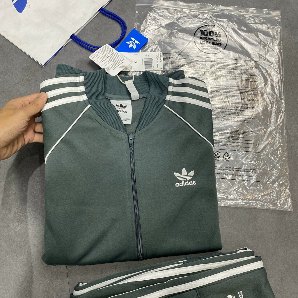 Bộ Quần Áo Thể Thao Unisex Nam Nữ Adidas SST Track Màu Xi Măng
