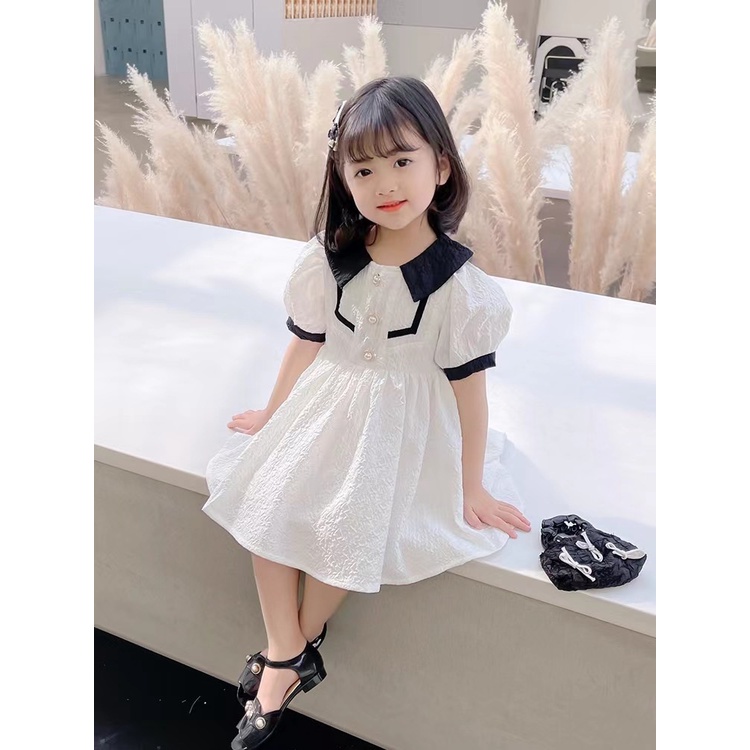váy xốp cổ nhọn cúc ngọc bé gái