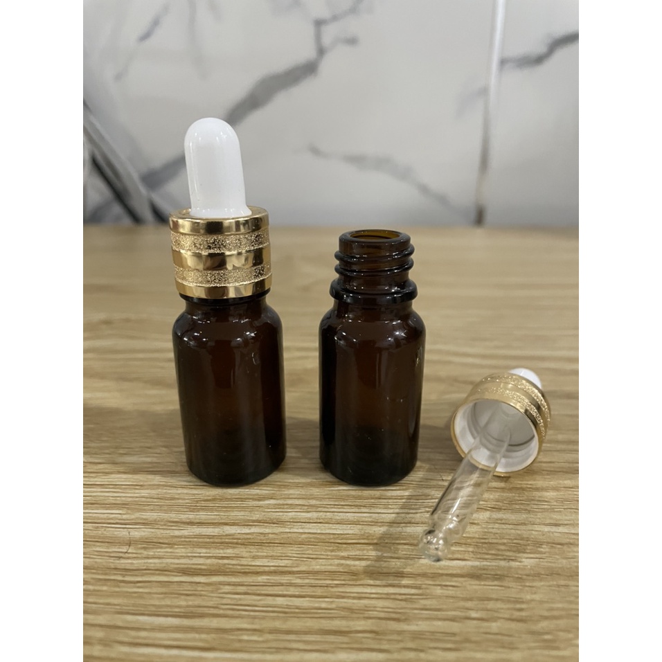 Chai thủy tinh 10ml nâu nắp bóp khoen vàng kiểu đẹp