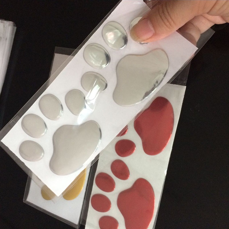 Bộ 2 Miếng Dán Trang Trí Xe Hơi Hình Dấu Chân Chó Mèo Gấu 3d Màu Vàng / Bạc