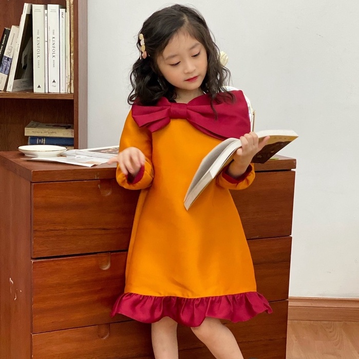 Váy lụa nơ xòe dài tay Candy 137KIDS màu cam đỏ cho bé gái đi chơi dự tiệc