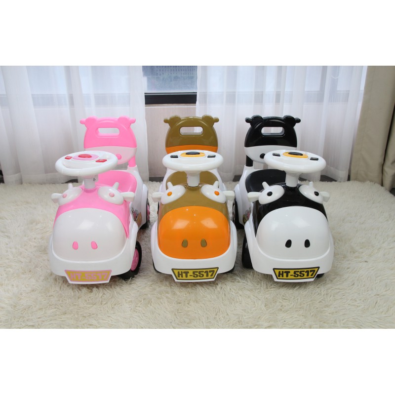 Xe chòi chân kiêm bám tập đi hình bò sữa cho bé có đèn nhạc và khoang đựng đồ Toys House HT-5517 màu vàng