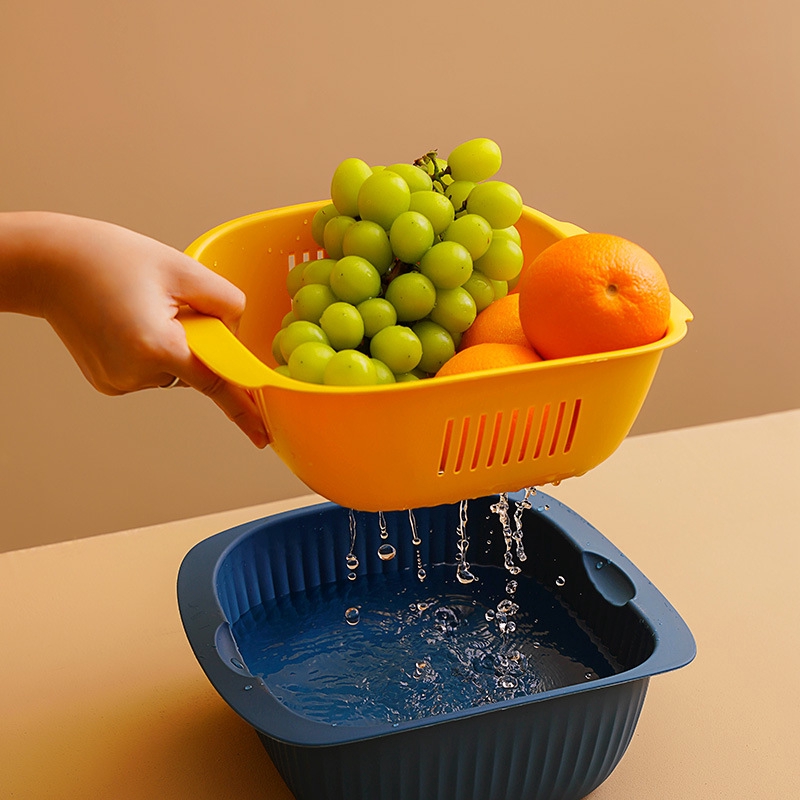 The plastic double-layer vegetable washing basket is a multifunctional fruit drain basket for household kitchens.
