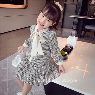 Váy kẻ cổ nơ đuôi cá bé gái
