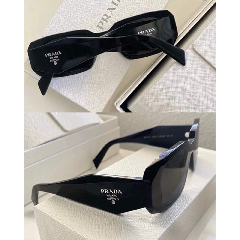 Kính râm Pra Da 2 màu đen trắng hot trend.Kiểu dáng unisex,phong cách hiện đại,sành điệu.Bản có logo 2bên,chống UV400