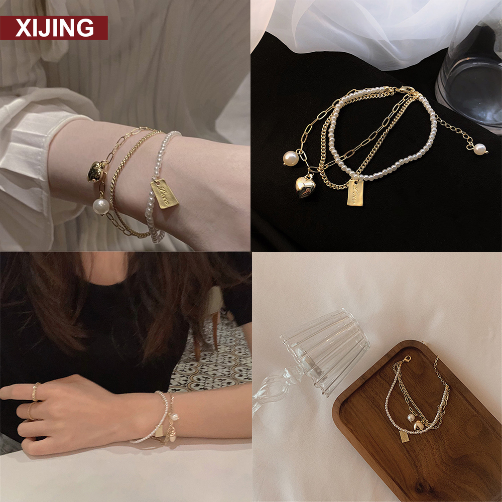 Vòng tay phối dây xích ngọc trai đính chuông hình trái tim thời trang sang trọng dành cho nữ