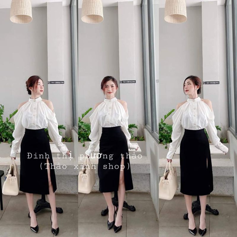 Áo sơ mi trắng khoét vai, chân váy đen xẻ tà ôn dáng
