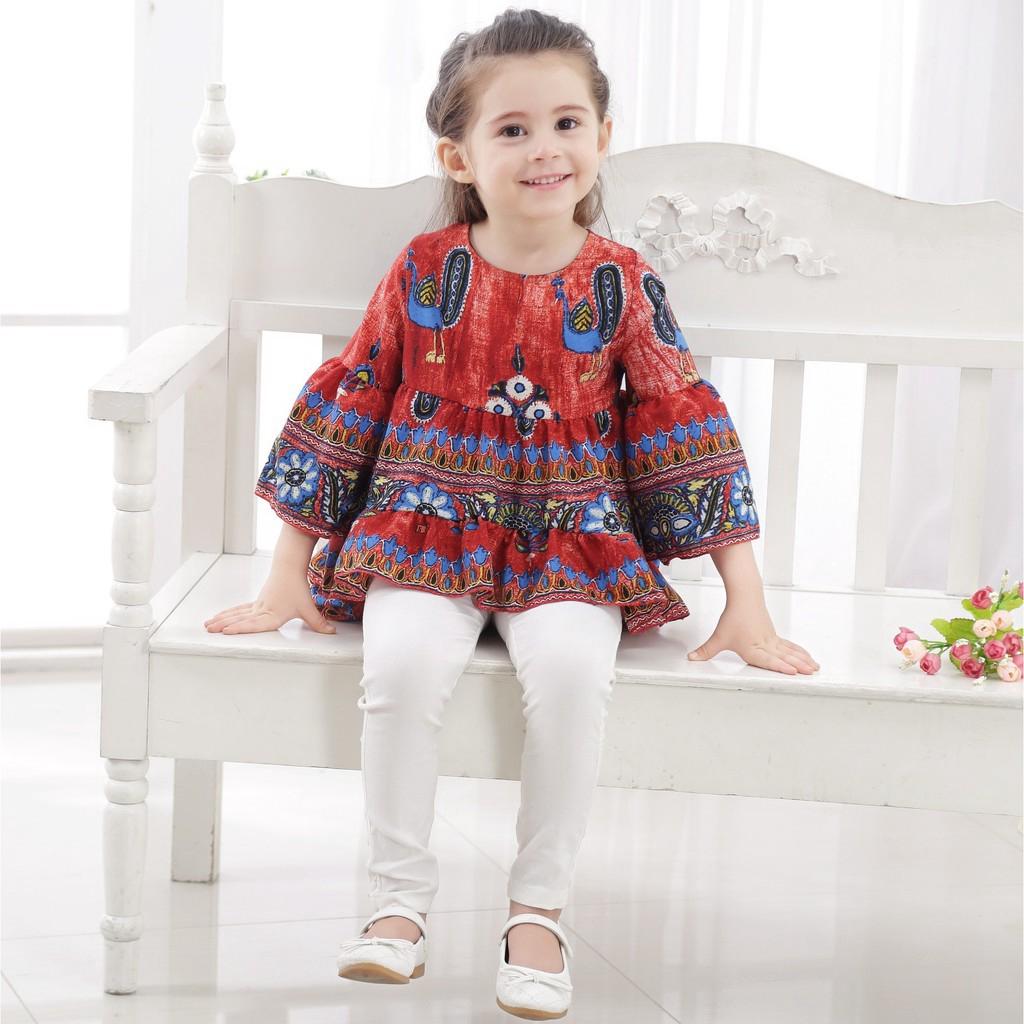 Áo cổ tròn tay ống loe họa tiết hoa phối trước ngắn sau dài dễ thương cho bé gái