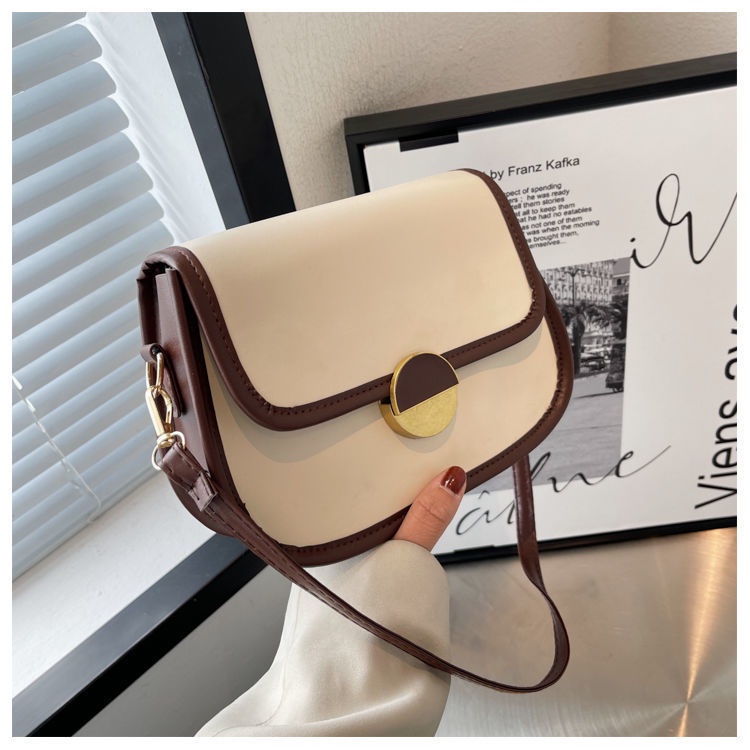 Túi xách nữ đeo chéo khóa tròn kiểu dáng yên ngựa thanh lịch có hai màu trắng và đen