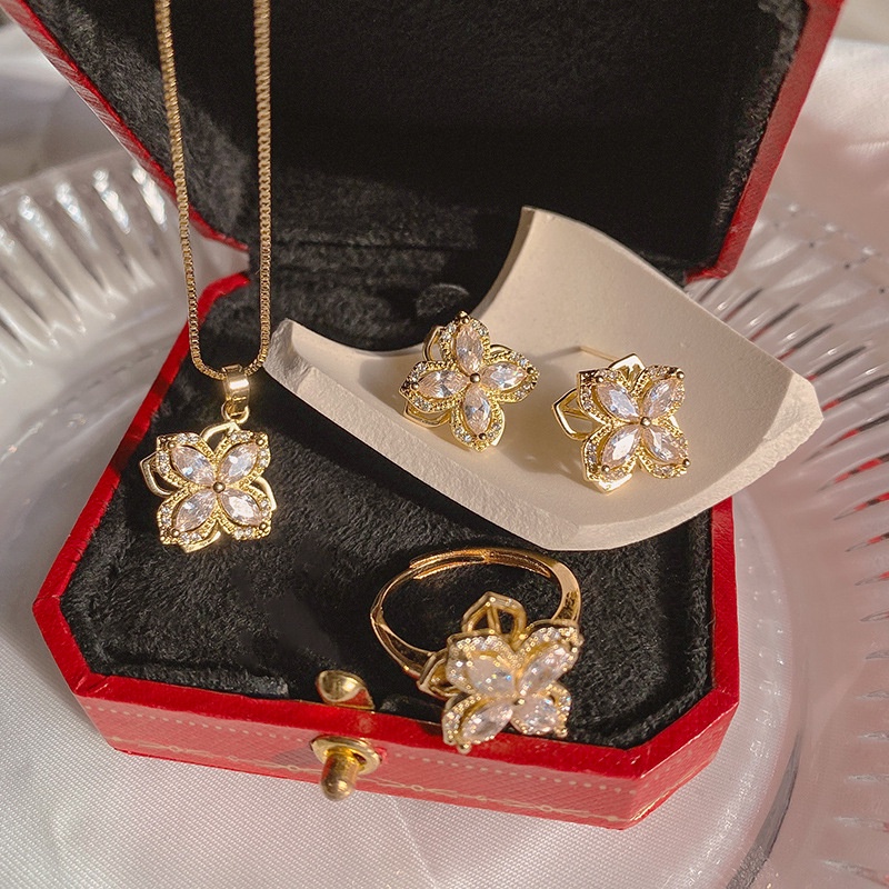 Dây chuyền/ Hoa tai/ Nhẫn mặt hoa bốn cánh đính đá zircon xoay được thời trang mùa hè dành cho bạn nữ