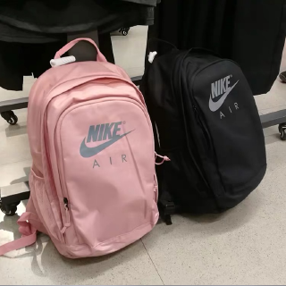 The plain color backpack features a unique Nike logo motif