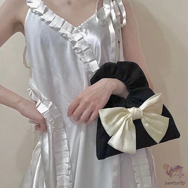 Túi xách cầm tay thiết kế xếp nếp gắn nơ thời trang Hàn Quốc cho trẻ em - người lớn