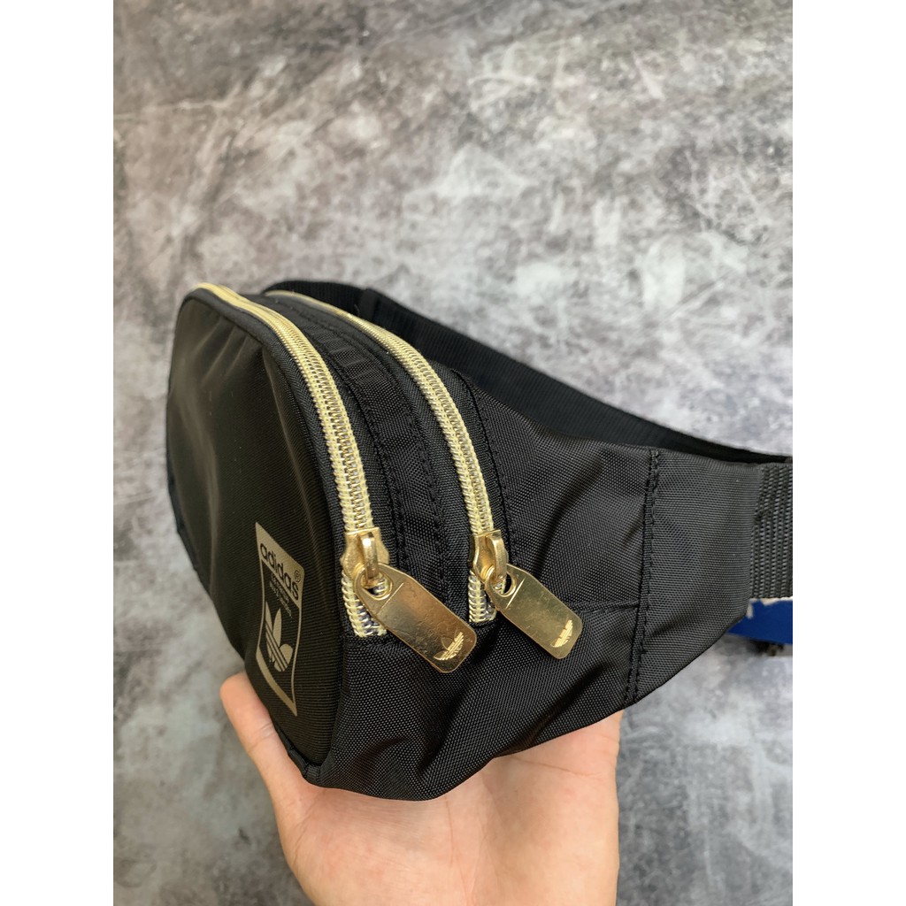 (THAILAND XUẤT XỊN) Túi bao tử das đen logo vàng, khóa vàng Adidas Originals Superstar Waist Bag Black/Gold GF3200