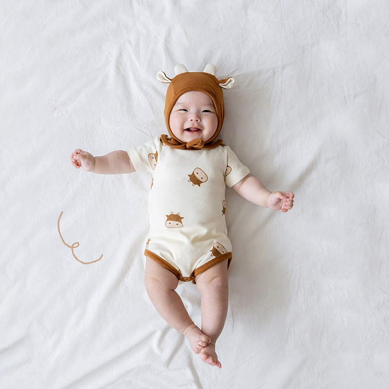 Bộ áo liền quần và mũ in hình bò sữa dễ thương cho trẻ sơ sinh