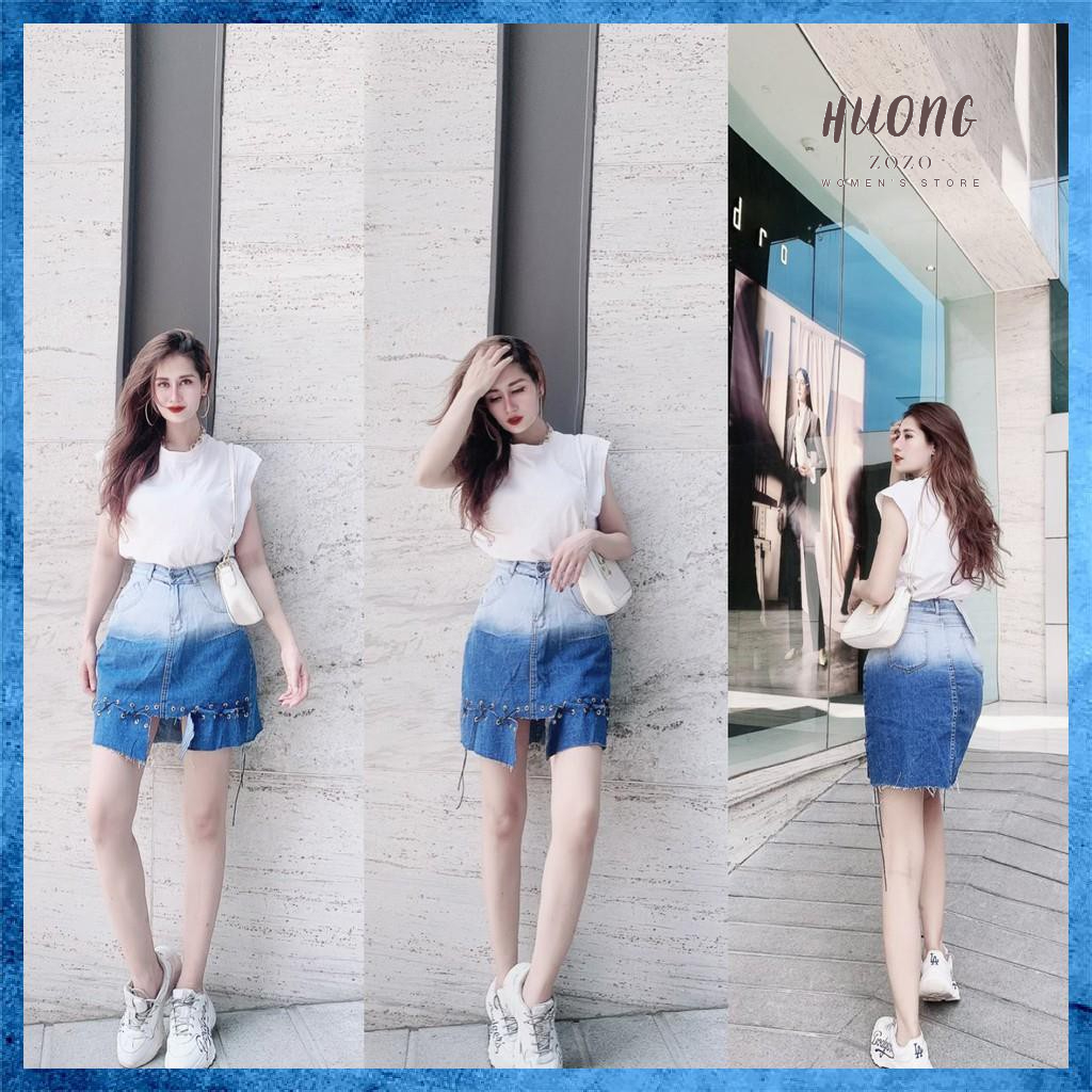 Chân váy denim ngắn, cạp cao loang màu túi chéo, gấu đan dây. Mã V9135