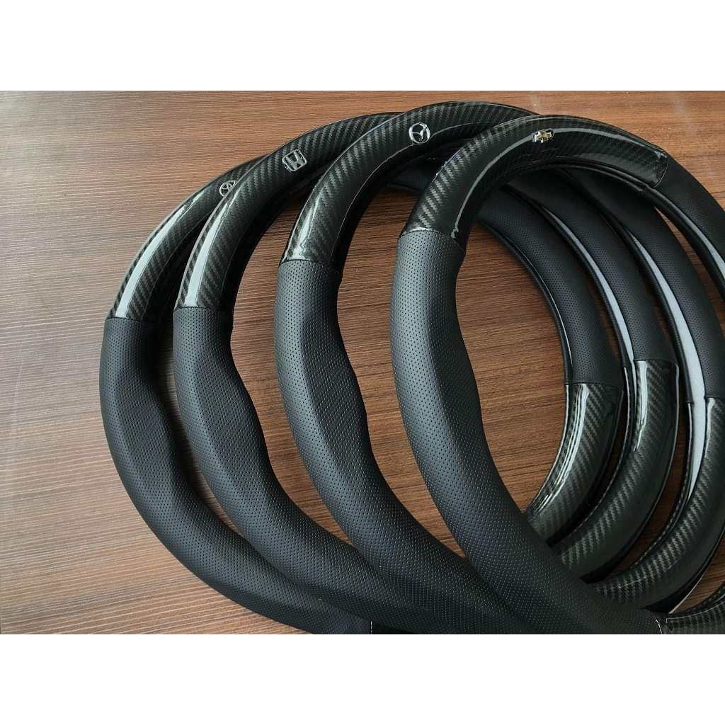 Bọc vô lăng ô tô Da vân Carbon kiểu dáng thể thao logo hãng xe,không gây mùi, chống trơn trượt