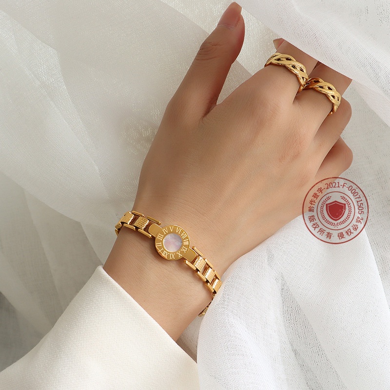 Đồng hồ đeo tay điện tử mặt tròn dây thép titan mạ vàng 18K E232